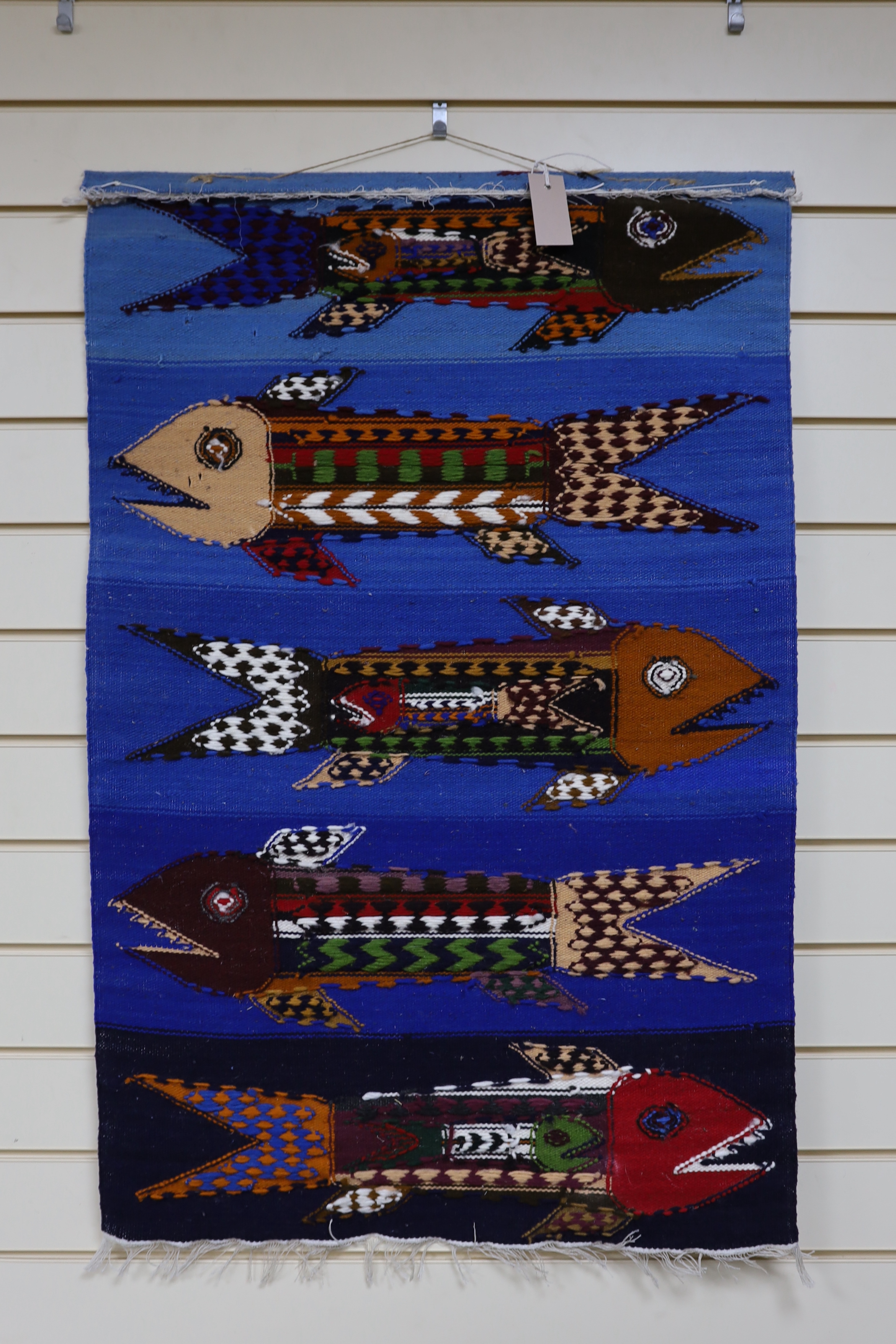 In the style of Evelyn Ackerman, hand hooked tapestry wall hanging, pregnant fish